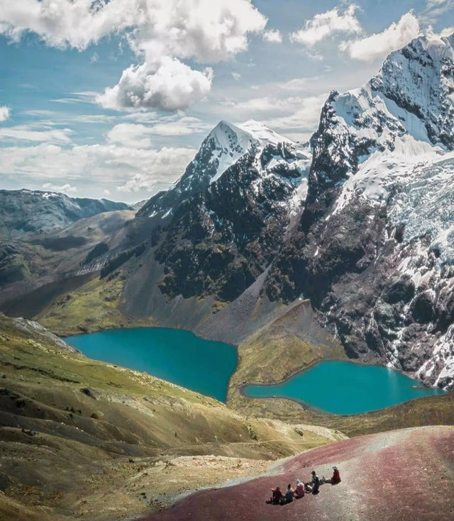 Ausangate snow capped mountain with a mineral blue lake