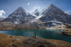 Snow-capped Ausangate peaks towering over a turquoise glacial lake in the Peruvian highlands