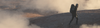 Person wearing Aire Long Sleeve base layer standing on a rocky outcrop in early morning fog at sunrise
