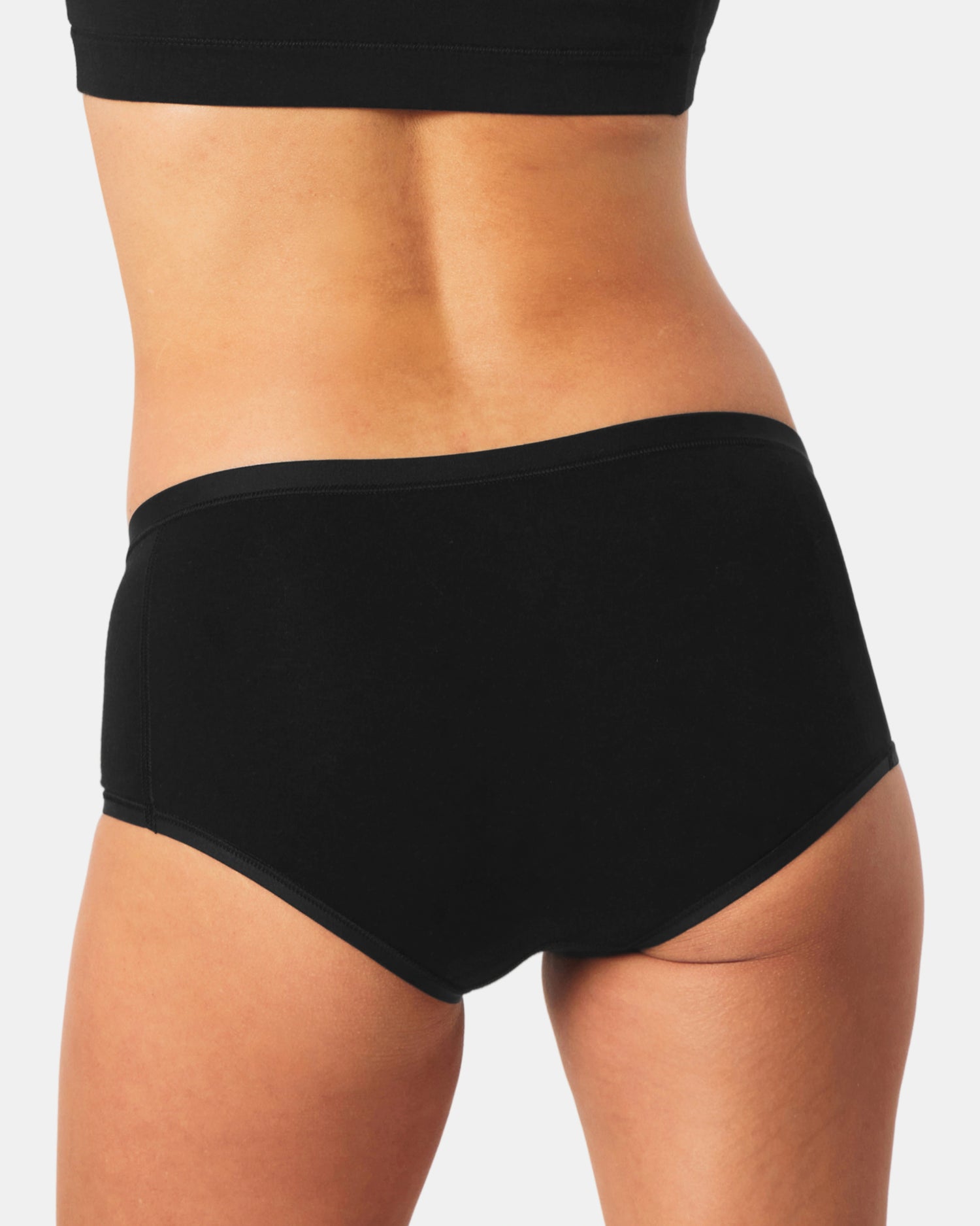 Person wearing black Women's Boy SHort underwear on a plain background