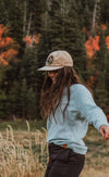 A smiling girl wearing The Crew outdoors