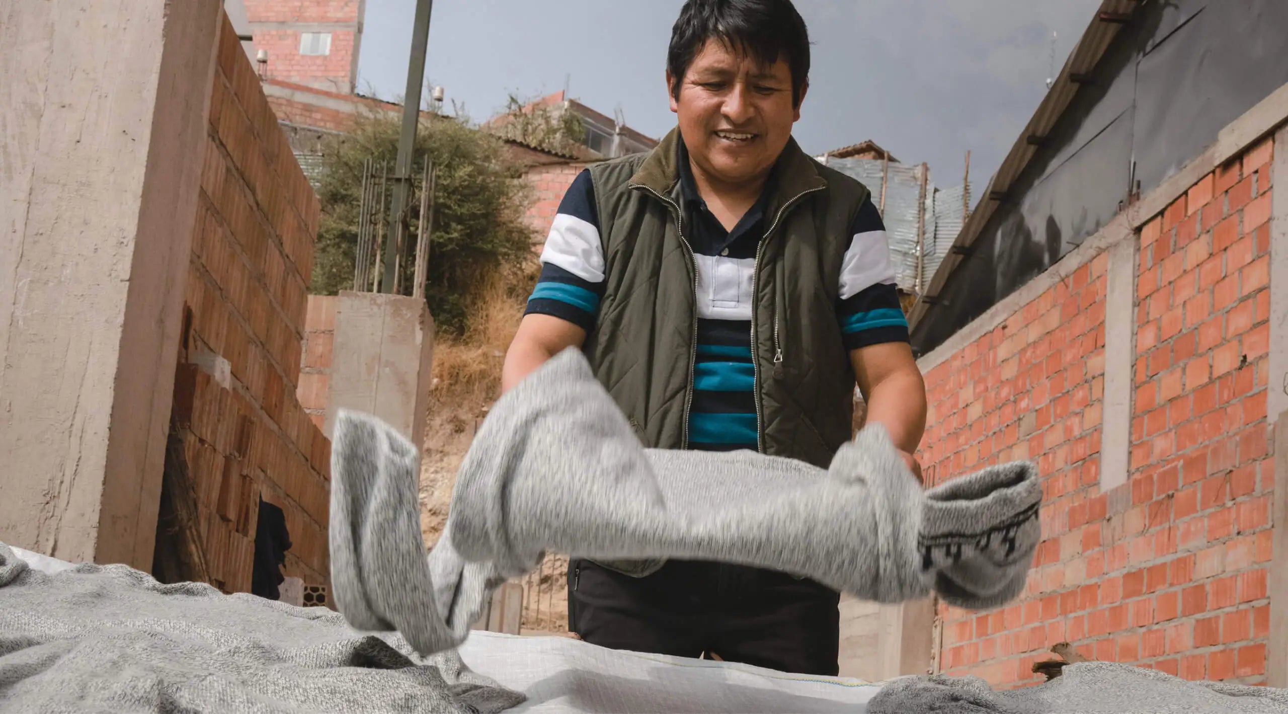 A man holding one of our Costa sweaters to air flat dry