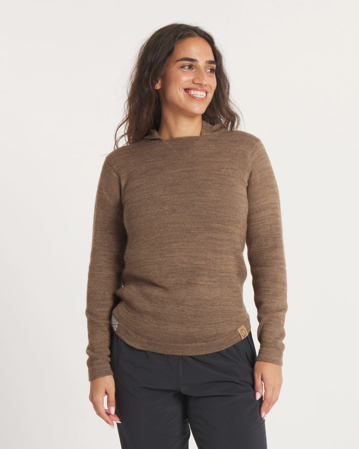 Front view of alpaca wool hoodie in Cafe Heather on model, relaxed fit with long sleeves and hood against light background