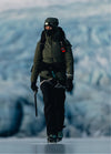 Woman in PAKA alpaca layers trekking across a glacier in Iceland with ice formations in the background