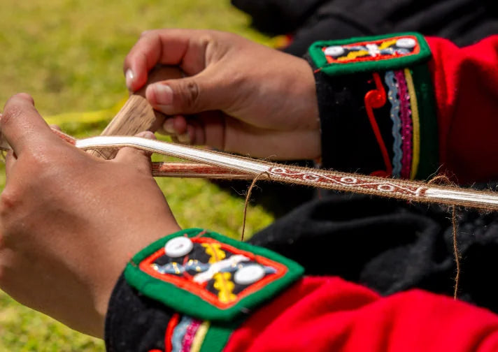 Woman's hands weaving a bracelet