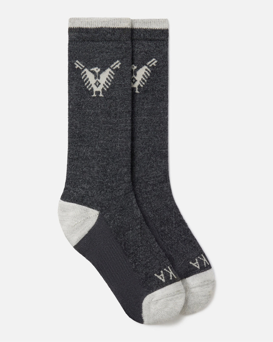 Top-down view of charcoal Condór crew socks with Inca condor motif and contrast gray heel and toe on white background