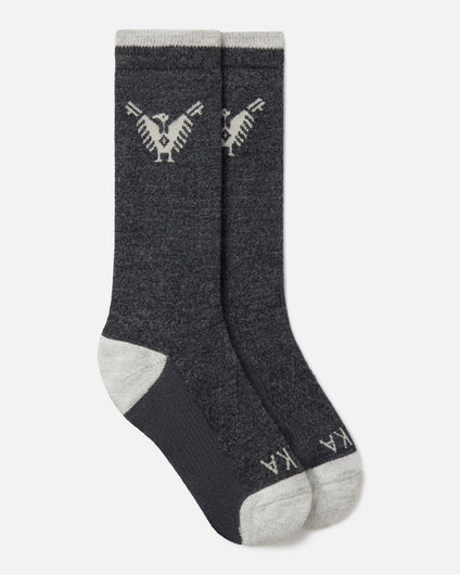 Top-down view of charcoal Condór crew socks with Inca condor motif and contrast gray heel and toe on white background