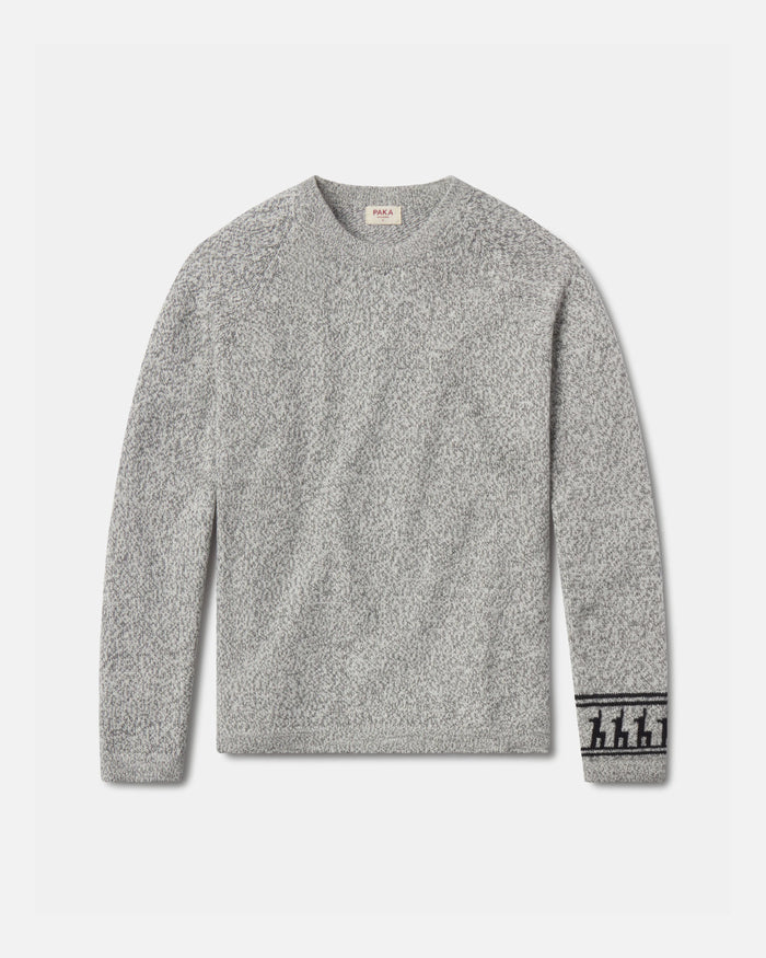 Front flat lay of The Costa alpaca sweater showcasing textured knit and patterned cuff in light grey on a light background