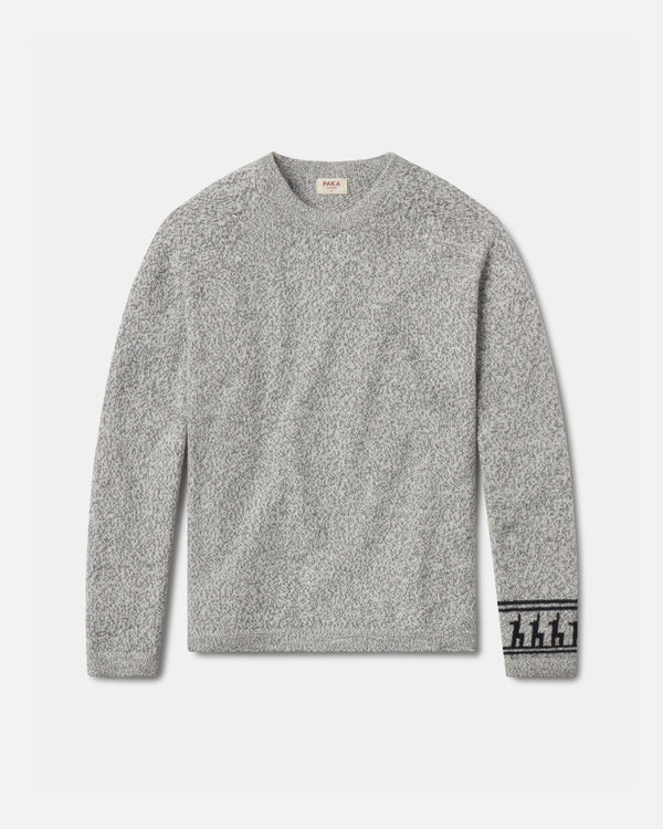 Front flat lay of The Costa alpaca sweater showcasing textured knit and patterned cuff in light grey on a light background