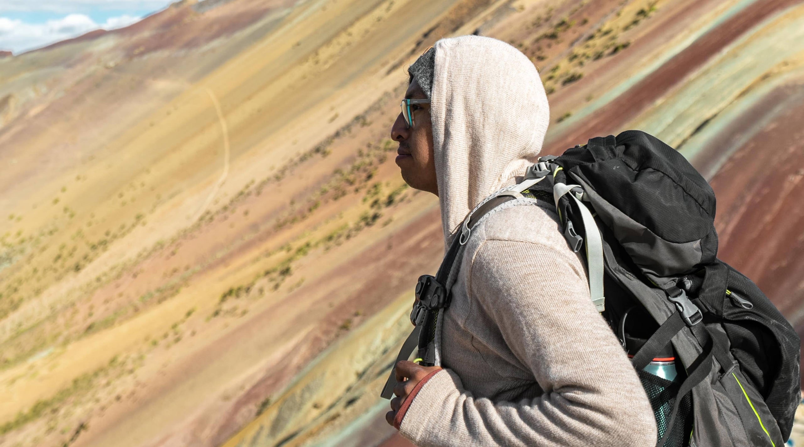 A backpacker in front of the Rainbow Mountain