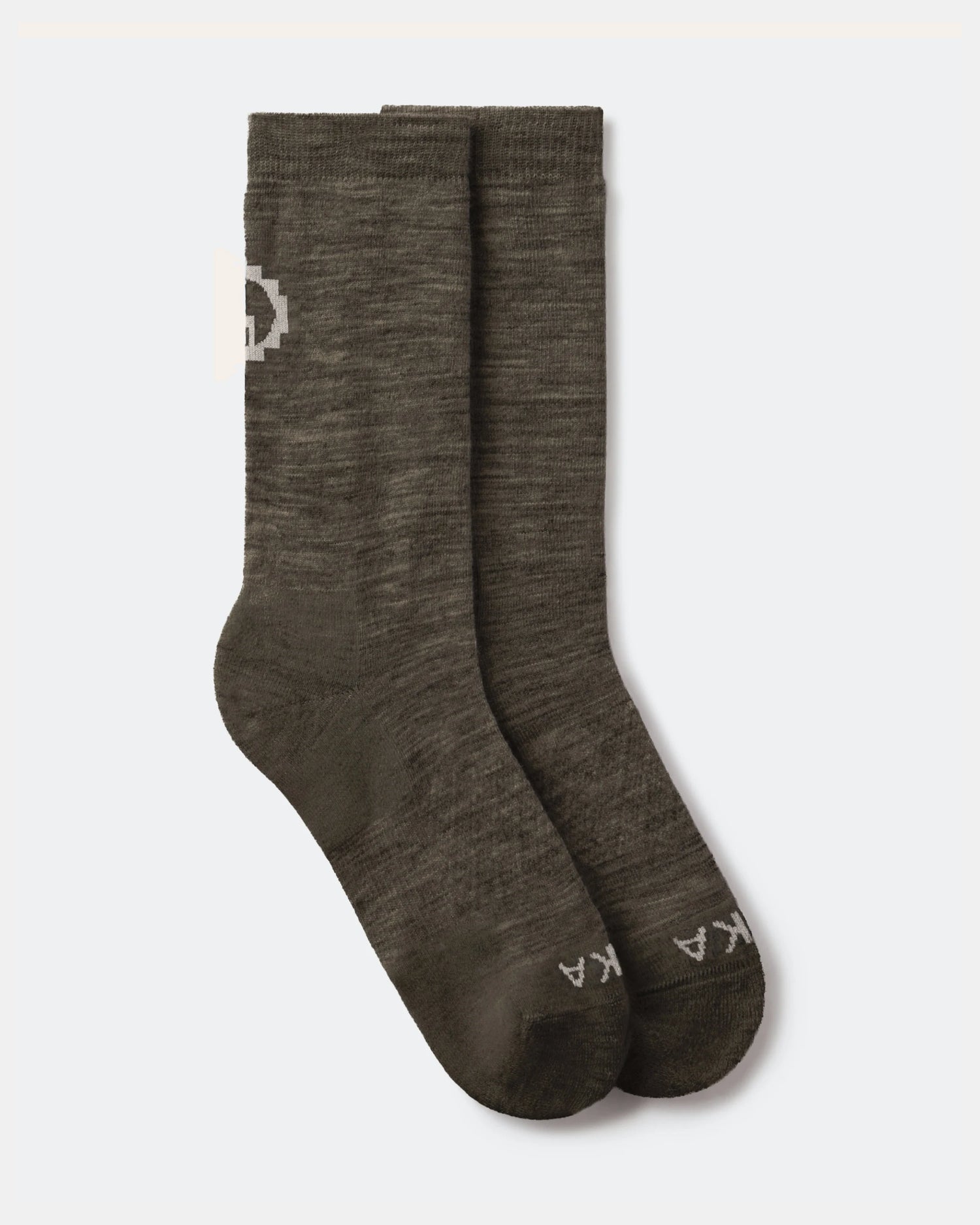Flat lay of Essential Crew Socks in Andean Moss showing crew height, alpaca knit texture and PAKA logo on a light gray background