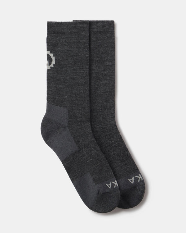 Top view of Essential Crew Socks in dark gray alpaca showing crew length, cushioned heel and logo on a light gray background