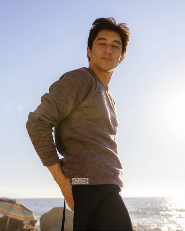 Man Wearing The Original Crew Alpaca Wool Sweater from Peru in Front of the Ocean – PAKA Apparel