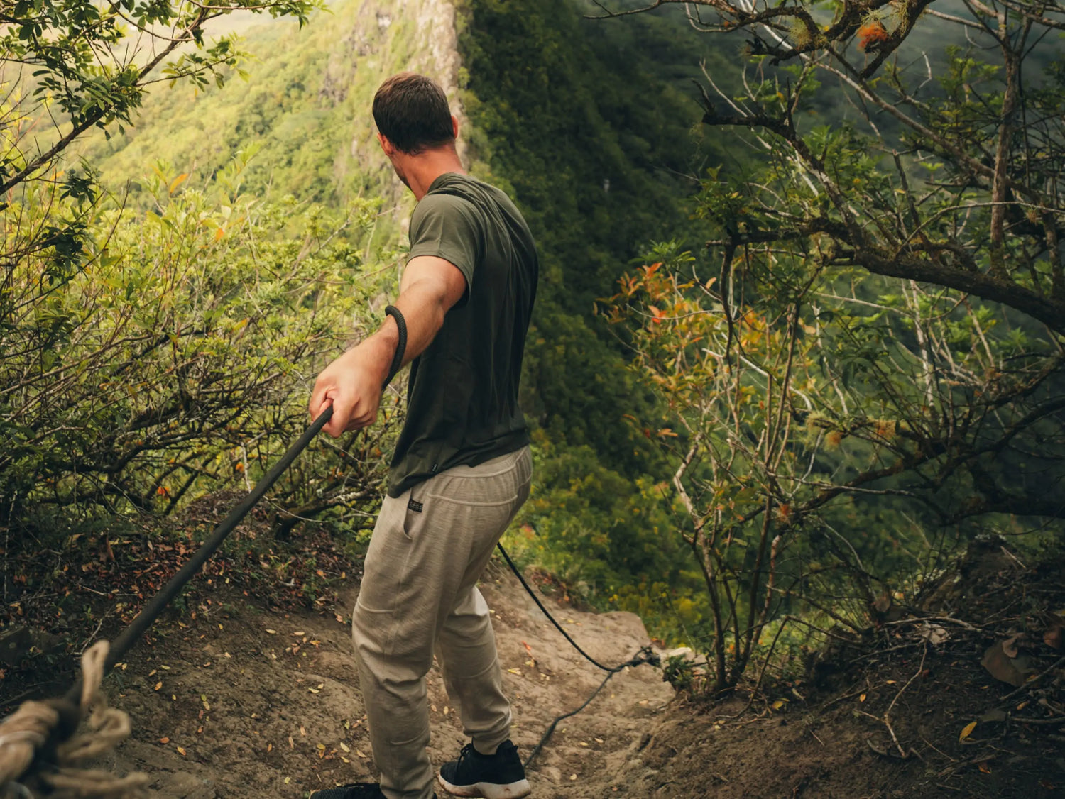 Man Hiking with a Rope in the Forest Wearing Green Alpaca Outdoor T-Shirt – PAKA Apparel