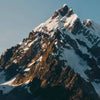 A snow-capped mountain at sunset 