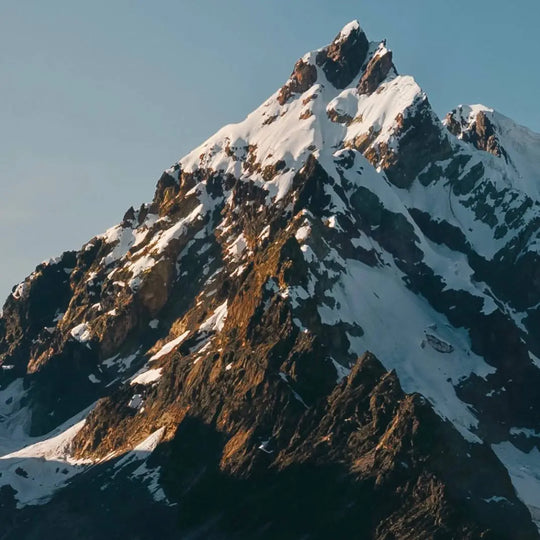 A snow-capped mountain at sunset 