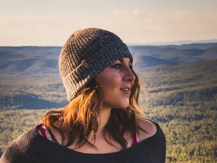 A woman wearing a gray alpaca beanie 