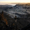 a hiker looking at the horizon between the mountains wearing an alpaca jacket