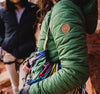 A woman wearing our green Pakafill puffer jacket