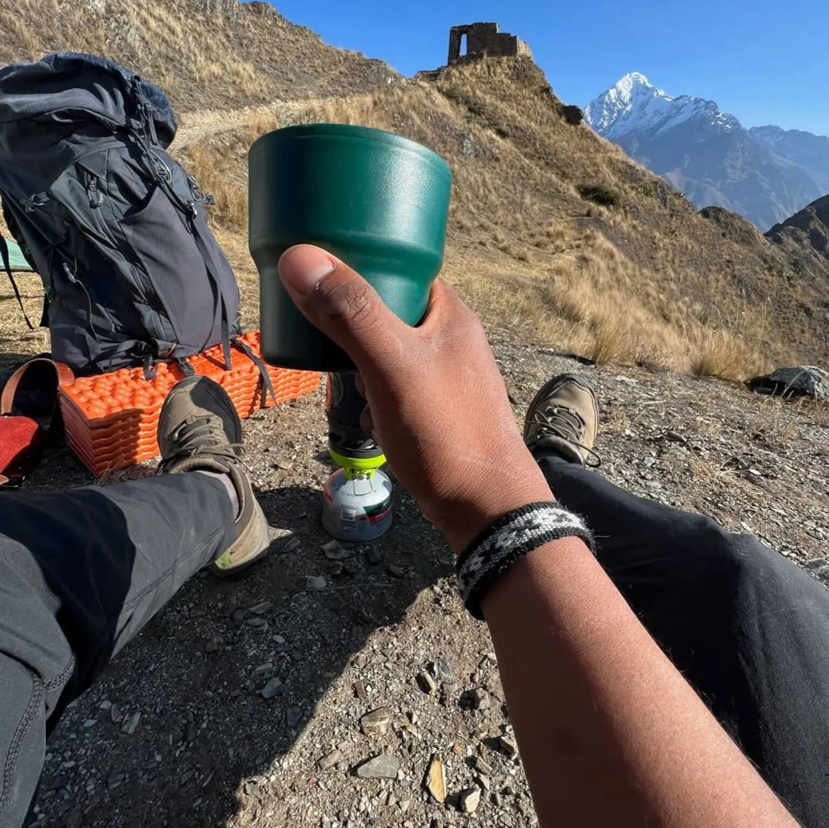 a man wearing our bracelets holding a coffee cup