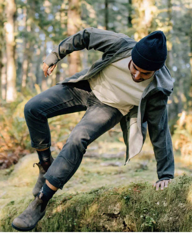 A man crossing the jungle in his alpaca Crew socks