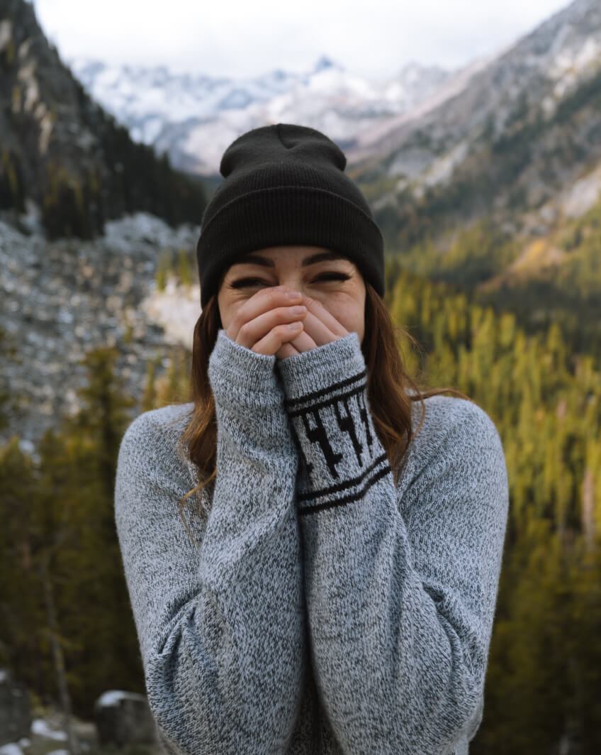 A woman wearing The Costa with her hands on her face