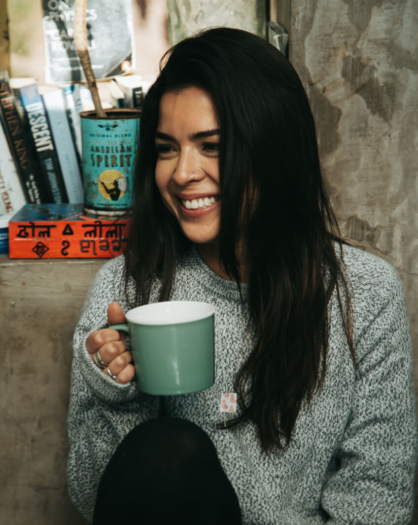 A girl in The Costa holding a cup