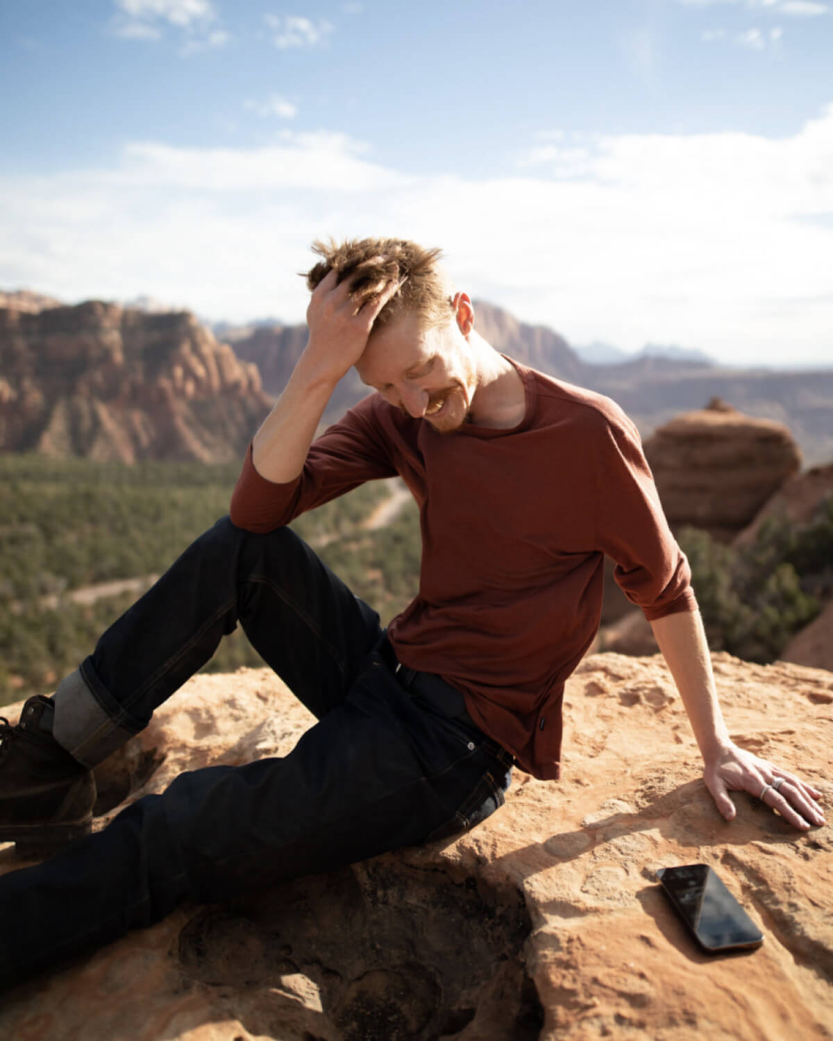 Man Named Josh Touching His Hair on a Desert Rock in Clay / Red Aire Breathable Long Sleeve Hiking Shirt – PAKA Apparel