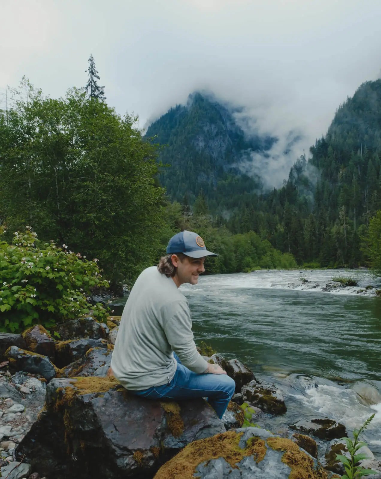 Man Named Milo Sitting by a River in Heather Grey Aire Long Sleeve Camp Shirt – PAKA Apparel