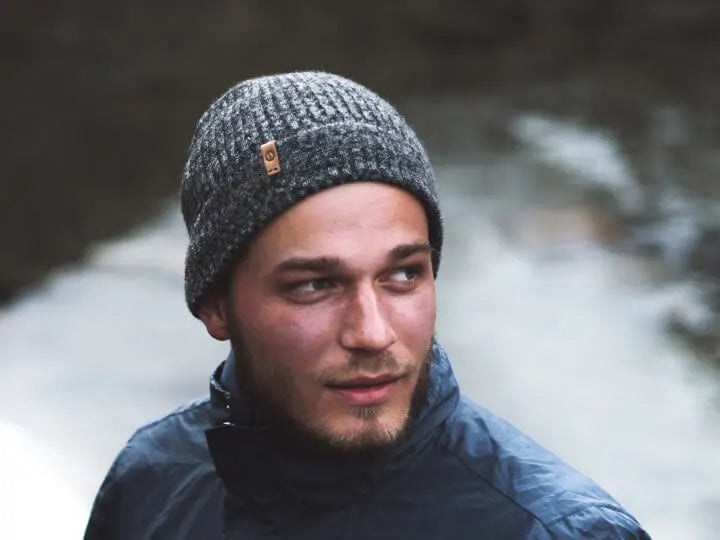 A man wearing a charcoal alpaca beanie