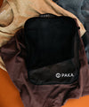 Front-open view of upcycled packing cube showing black interior with mesh pocket and visible PAKA logo on fabric background