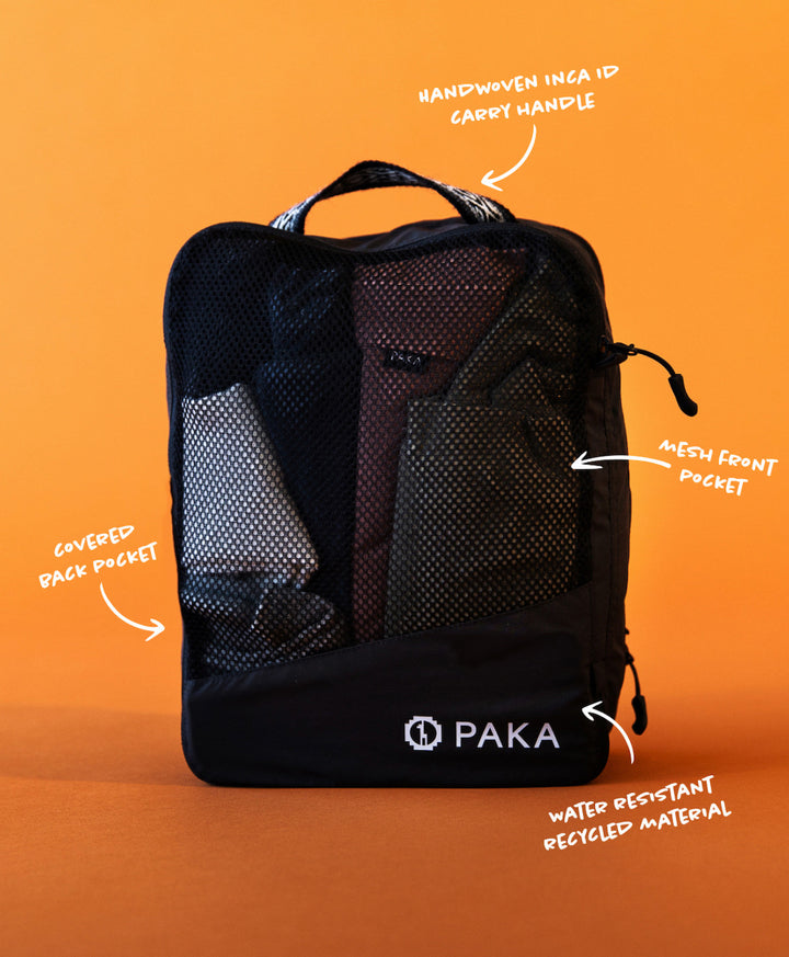 Front view of Upcycled Packing Cube showing mesh pocket, top handle, and zip closure on orange background