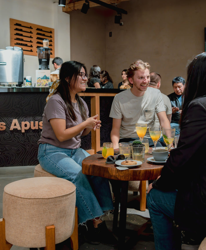 Customers seated at café inside PAKA flagship store in Cusco with alpaca clothing displays