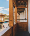 Interior wooden balcony of Paka’s Cusco flagship store overlooking the Plaza de Armas