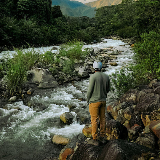 A man wearing an Eucalyptus Men's Baselayer in front of a river 