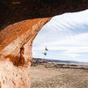 Two women suspended from a great height, fastened to the rocks