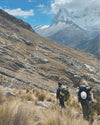 Two men walking up a mountain.