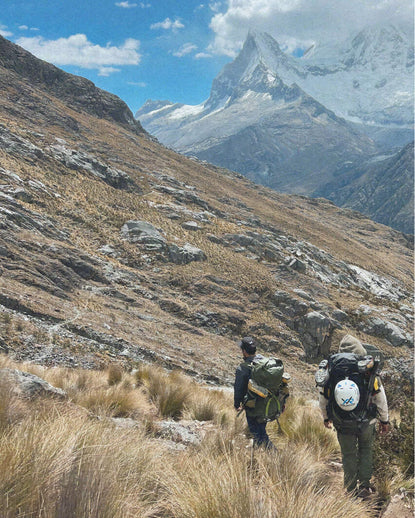 Two men walking up a mountain.