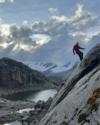 Man climbing mountain with a rope