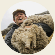Kris, the founder, holding an alpaca
