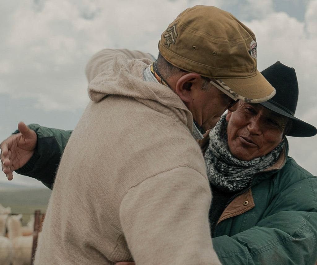 Two men hugging in the Peruvian highlands