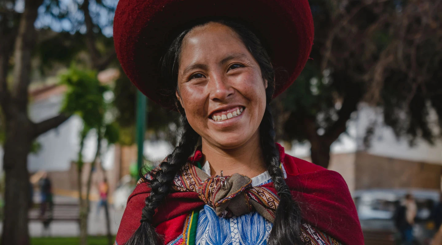 Noemi, one of our scholars wearing her traditional dress showing a big smile