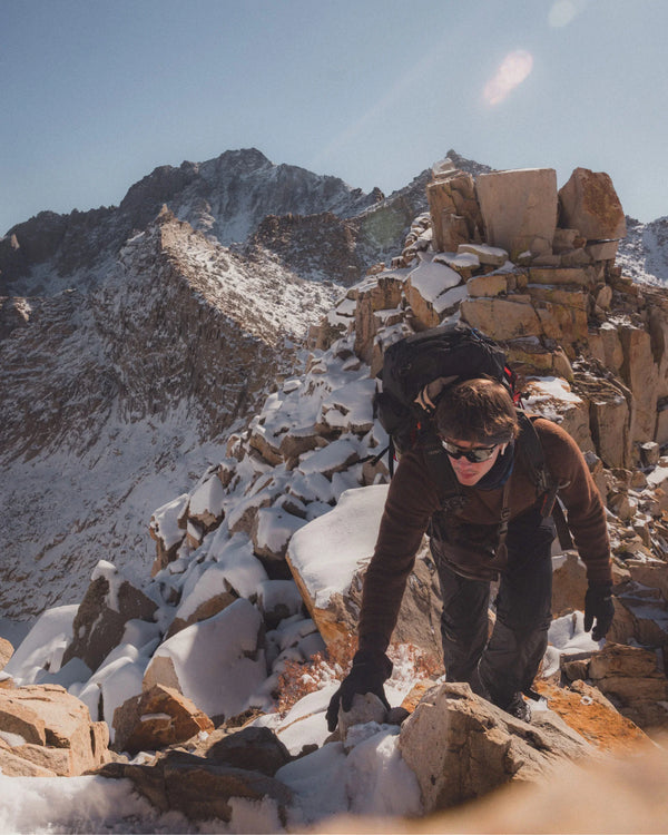 Hiker with Pack Climbing Snowy Mountain in The Hoodie Cocoa Dark Brown Alpaca Sweater with Hood – PAKA Apparel