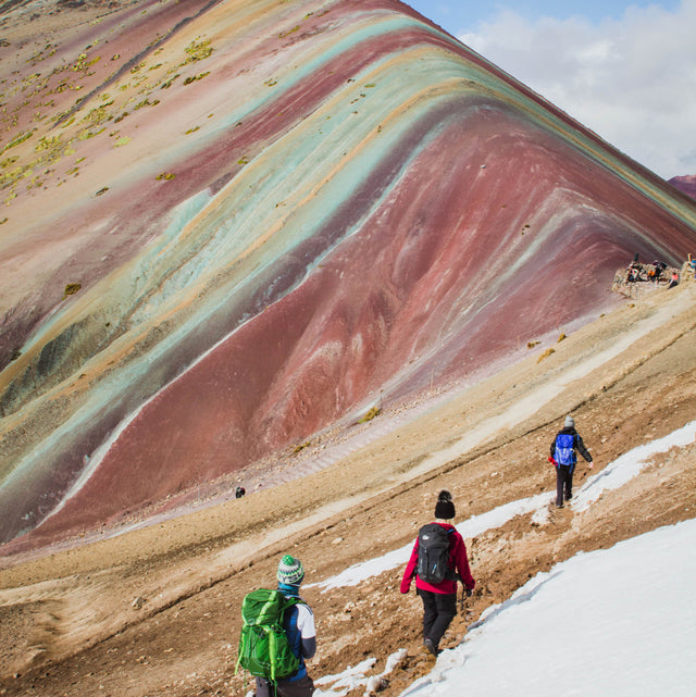 Three people backpacking on the rainbow mountain