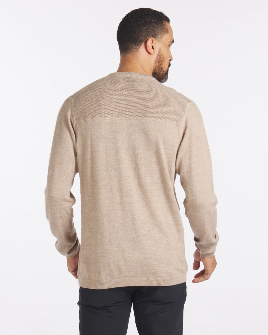 Back view of The Lightweight Crew in tan showcasing textured knit yoke and relaxed fit on a male model with white background