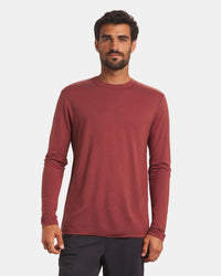 Front view of Men’s Aire long-sleeve alpaca shirt in clay on model showing crew neck and regular fit with light gray background