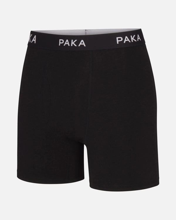 Front view of Essential Boxer Brief in black with PAKA elastic waistband and mid-thigh length on white background
