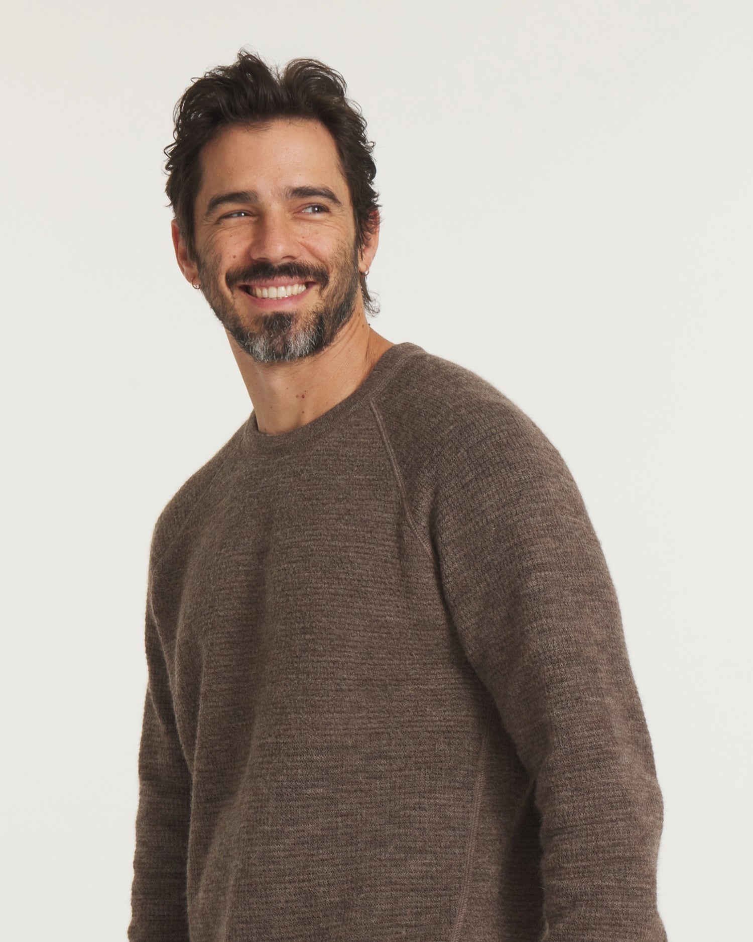 Three-quarter view of Men’s Mountain Crew sweater with raglan sleeves and heathered wood-brown knit on light background