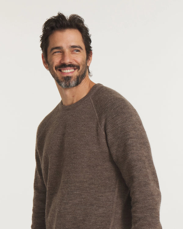 Three-quarter view of Men’s Mountain Crew sweater with raglan sleeves and heathered wood-brown knit on light background