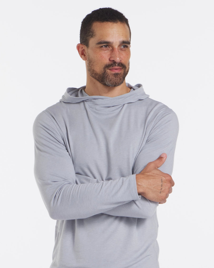 Front three-quarter view of Men’s Sol Hoodie showcasing lightweight draped hood and slim fit on model against white background